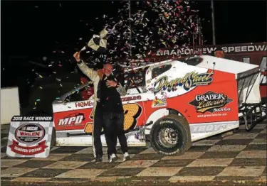  ?? RICH KEPNER - FOR DIGITAL FIRST MEDIA ?? Ray Swinehart gets a hug from wife Lori after winning the Forrest Rogers Memorial at Grandview on Sept. 1.