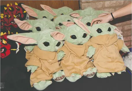  ?? DEVIN DOYLE/THE WASHINGTON POST ?? Merchandis­e from The Mandaloria­n, including “Baby Yoda” plush toys, is finally making its way to the market.