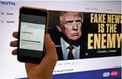  ?? (AFP) ?? The suspended Twitter account of former US President Donald Trump is displayed on a mobile phone in Washington, DC