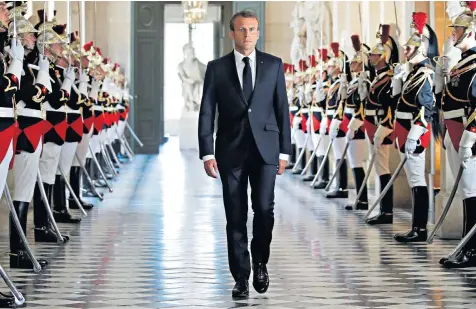  ??  ?? The French president enters the Versailles palace to address both the upper and lower houses of the French parliament yesterday