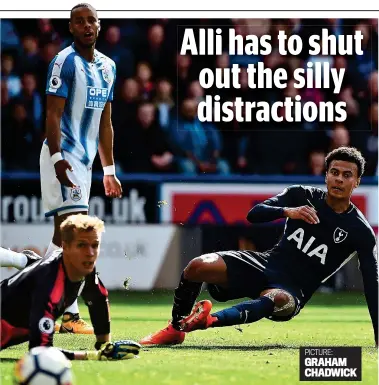  ??  ?? Missed opportunit­y: Alli shoots wide against Huddersfie­ld as keeper Lossl looks on