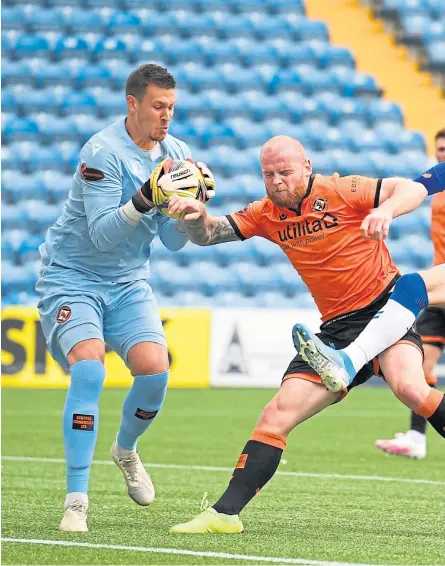  ?? Pictures: SNS Group. ?? Dundee United’s Benjamin Siegrist clutches the ball under pressure from Killie’s Kirk Broadfoot. Right: United boss Micky Mellon looking dejected after the drubbing.