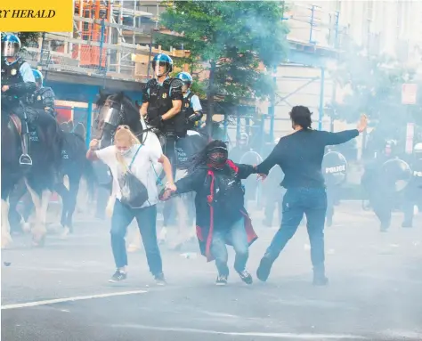  ?? ROBERTO SCHMIDT / AFP VIA GETTY IMAGES ?? Protesters are tear-gassed by police officers on Monday near the White House. Demonstrat­ions against police brutality continued across the U.S. Monday in the wake of George Floyd’s death.