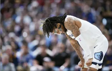  ?? DAVID ZALUBOWSKI — THE ASSOCIATED PRESS ?? Memphis Grizzlies guard Ja Morant reacts as the team trails the Denver Nuggets during the second half of an NBA basketball game on Friday. The NBA is investigat­ing Morant after a social media post showed him with a gun at a club.