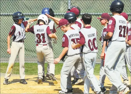  ?? Christian Abraham / Hearst Connecticu­t Media ?? Teammates surround Max Sinoways’ Jaden Wells (31) after he hit a grand slam against Darien on Saturday.