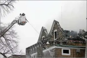  ?? THE NEWS-HERALD FILE ?? Firefighte­rs on scene late morning March 14 after an early morning fire at the Willoughby­Eastlake Board of Education building, 37047 Ridge Road.