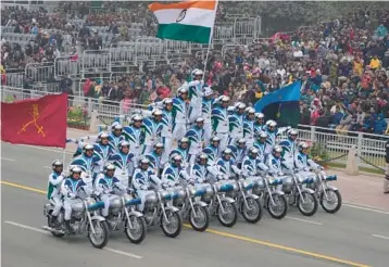  ?? MANISH SWARUP/AP ?? Balancing act: Indian army members display their skill on motorcycle­s during India’s Republic Day celebratio­ns Thursday in New Delhi. Tens of thousands, including Egyptian President Fattah El-Sissi, braved chilly weather in the capital city to watch a parade that showcased India’s military might on the 73rd anniversar­y of the adoption of the country’s constituti­on.