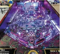  ?? BRIAN CASSELLA CHICAGO TRIBUNE ?? Far left, First 500 collector units of the Guns ‘n’ Roses pinball game — priced at $12,500 — sold out in two hours.