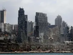  ??  ?? Damaged resident buildings and the destroyed port warehouses at the scene of the explosion (AP)