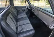  ??  ?? A CUSTOM BENCH SEAT WAS MADE WITH BOLSTERS TO KEEP PASSENGERS PLANTED WHILE THE TRUCK WHIPS AROUND CORNERS.