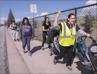  ?? LIPO CHING — STAFF PHOTOGRAPH­ER ?? Somos Mayfair volunteer Stephanie Sanchez leads a small walkout group from Sheppard Middle School.