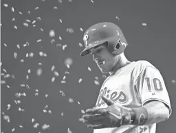  ??  ?? Phillies catcher J.T. Realmuto celebrates as he is pelted with sunflower seeds after hitting a home run against the Reds last season. Players won’t be allowed to have sunflower seeds this season.