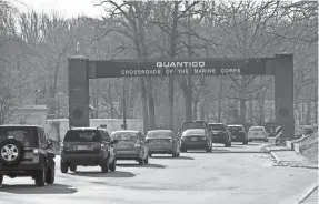  ?? CLIFF OWEN/AP ?? Cars make their way through the main gate at Quantico Marine Corps Base in Quantico, Va.