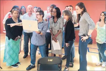  ?? Matt Pearce ?? DIRECTOR NICK DeGRUCCIO, center, discusses the play with cast members, some of whom resigned, citing disagreeme­nts over the play’s interpreta­tion of the shooting of Michael Brown by a Missouri police officer.