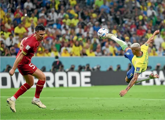  ?? GETTY IMAGES ?? Richarliso­n scored both goals, the second from this stunning, acrobatic volley, in Brazil’s 2-0 win over Serbia at the World Cup yesterday.