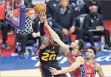  ?? YONG KIM/The Philadelph­ia Inquirer/TNS ?? Philadelph­ia 76ers guard Ben Simmons attempts to block Atlanta Hawks forward John Collins’ fast break lay-up attempt during the third quarter in Game 1 of the NBA Eastern Conference playoff semifinals on Sunday, June 6, 2021. No foul was called on the play.