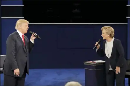  ?? THE ASSOCIATED PRESS ?? Republican presidenti­al nominee Donald Trump and Democratic presidenti­al nominee Hillary Clinton exchange ideas during the second presidenti­al debate at Washington University in St. Louis on Sunday.