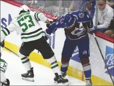  ?? DAVID ZALUBOWSKI/AP ?? DALLAS STARS CENTER WYATT JOHNSTON (53) battles for control of the puck with Colorado Avalanche defenseman Cale Makar (right) in the rst period of Game 4 of a playoff series on Monday in Denver.