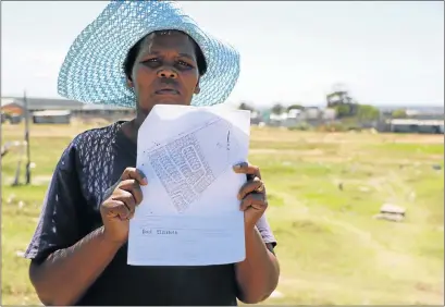  ?? Picture: RIAAN MARAIS ?? LONG WAIT: Community leader Nomathemba Tshumsila shows the plans drawn up in 1999 for a housing developmen­t in Sharpville that has yet to be built