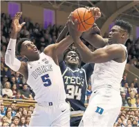  ?? STREETER LECKA GETTY IMAGES ?? A judge ruled Friday that the NCAA may continue to cap payments to student-athletes such as Duke’s R.J. Barrett of Mississaug­a, left, and freshman star Zion Williamson.