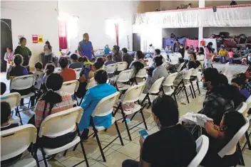  ??  ?? Pastor Gustavo Banda Aceves introduces himself to the group of asylum seekers dropped off Thursday. The asylum seekers were also presented with informatio­n about the shelter at Templo Embajadore­s de Jesus.