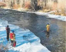  ?? Provided by The Basalt Fire Department to The Vail Daily ?? A member of the Basalt Fire Department fished 14 bottles suspected of being part of a the cold-cook method of methmaking out of the Roaring Fork River last month.