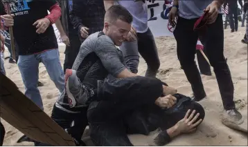  ?? MINDY SCHAUER — STAFF PHOTOGRAPH­ER ?? Robert Paul Rundo holds down and punches a counterpro­tester at a political rally at Bolsa Chica State Beach in Huntington Beach on March 25, 2017, according to federal authoritie­s.