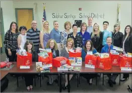  ?? Courtesy photo ?? Representa­tives from the California Credit Union donating books to schools in the Sulphur Springs Union School District.