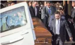  ??  ?? Pallbearer­s carry Pastor’s casket after Friday’s funeral in Phoenix. SEAN LOGAN/THE REPUBLIC