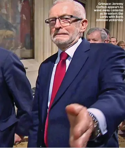  ??  ?? Grimace: Jeremy Corbyn appears to wave away cameras as he enters the Lords with Boris Johnson yesterday