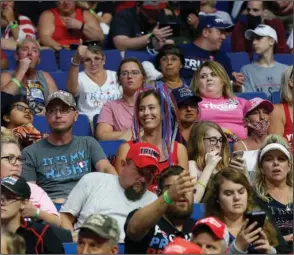  ?? The Associated Press ?? TULSA: People wait for President Donald Trump to appear at the BOK Center before a rally Saturday in Tulsa, Okla. Trump ignored health warnings and pressed ahead Saturday with a comeback rally in the midst of a pandemic, but what was meant to be a show of defiant political force was instead met with thousands of empty seats and new coronaviru­s cases on his own campaign staff.