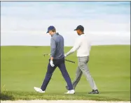  ?? Ross Kinnaird / Getty Images ?? Jordan Spieth, left, and Tiger Woods walk down the 10th fairway during a practice round prior to the U.S. Open at Pebble Beach Golf Links on Wednesday.