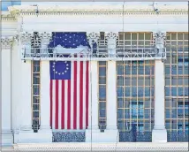  ?? [PATRICK SEMANSKY/ THE ASSOCIATED PRESS] ?? Workers install a flag on the West Front of the U.S. Capitol as preparatio­ns take place for President-elect Joe Biden's inaugurati­on on Saturday in Washington.