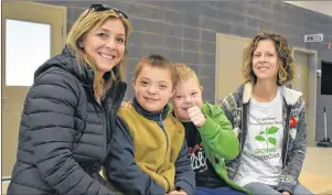  ?? NIKKI SULLIVAN/CAPE BRETON POST ?? Lynn Levatte, from left, Charles Levatte, Owen Long and Kim Long sit in the Membertou Sports and Wellness Centre. The two moms are advocates for their boys who have Down syndrome and hope to continue to raise awareness about people with it.