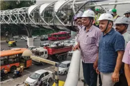  ?? — PTI ?? Delhi deputy CM Manish Sisodia along with Cabinet colleague Satyendar Jain inspect the constructi­on work of the sky- walk at Tilak Marg near ITO on Saturday.