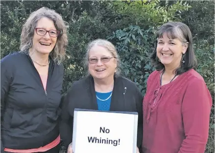  ?? COURTESY PHOTO ?? First Thursday Education Support Group founders Ellen Adams, Kathryn Treanor and Rosa Crocker with their motto, “No Whining!”