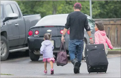  ?? GORD WALDNER/THE STAR PHOENIX FILES ?? La Ronge evacuees pack up to go home in this photo taken last week, leaving behind the SaskTel Soccer Centre in Saskatoon, their home for the last three weeks.