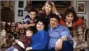  ?? DAN WATSON, THE ASSOCIATED PRESS ?? “Roseanne” cast back in the day: Michael Fishman, seated from left, Roseanne Barr, John Goodman, and second row from left, Sara Gilbert, Alicia Goranson and Laurie Metcalf.