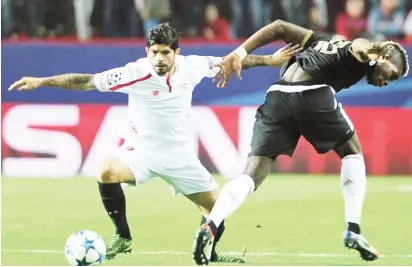  ??  ?? Manchester United’s Paul Pogba (right) fights for the ball against a Sevilla defender during their UEFA Champions League clash on March 13, 2018