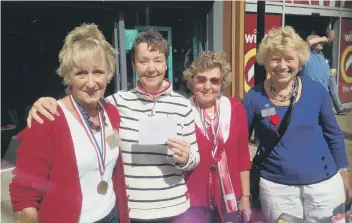  ?? SUBMITTED ?? St Catherine’s Hospice volunteers hold the winning cheque after their stall was judged the ‘best dressed’.