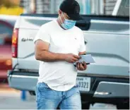  ?? Yi-Chin Lee / Staff photograph­er ?? Rossel Mardiga leaves an East End CVS Pharmacy after waiting for two hours Thursday in hopes of getting a leftover vaccine dose.