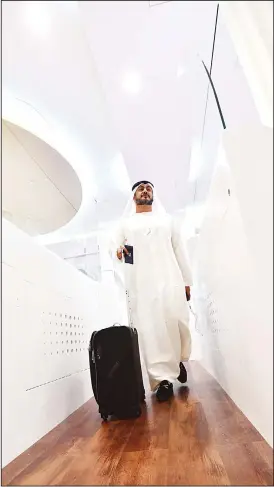  ??  ?? A passenger walks through a ‘Smart tunnel’ at Dubai airport T3 in United Arab Emirates on Oct 10. The Smart tunnel using face recognise technology, will check the passengers passport asthey walk through it. (AFP)