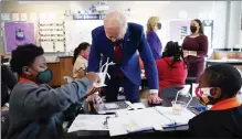  ?? MANUEL BALCE CENETA / AP ?? President Biden talks to students last month at Brookland Middle School in Washington as first lady Jill Biden talks with Brookland science teacher Michelle Taylor in the background.