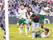  ?? DAVID ZALUBOWSKI AP ?? Portland defender Larrys Mabiala (back right) kicks the ball in for the winning goal against Colorado.