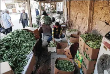  ?? SAMEER AL-DOUMY/AFP ?? A Syrian man sells vegetables on the street in the rebel-held town of Douma, on the eastern outskirts of Damascus on Saturday.