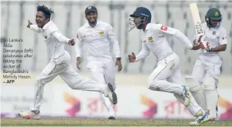  ?? — AFP ?? Sri Lanka‘s Akila Dananjaya (left) celebrates after taking the wicket of Bangladesh’s Mehidy Hasan.