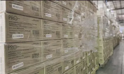  ?? PROVIDED ?? This photo from this month provided by Prestige Ameritech shows boxes of the company’s N95 masks in warehouse storage at North Richland Hills, Texas, outside of Fort Worth. One year into the COVID-19 pandemic, the U.S. finds itself with many millions of N95 masks pouring out of American factories and heading into storage. Yet there still aren’t nearly enough in ICU rooms and hospitals.