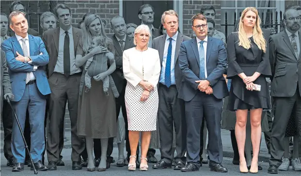  ?? ?? Joining his wife Carrie, aides and supporters line up behind Boris Johnson outside No 10 on July 7 as he announced his resignatio­n as Prime Minister. Several are reportedly being given peerages in his resignatio­n honours list: in colour from left to right, former minister of state Nigel Adams, ex-culture Secretary Nadine Dorries, Scottish Secretary Alister Jack, former No 10 deputy chief of staff Ben Gascoigne and ex-downing Street special adviser Charlotte Owen