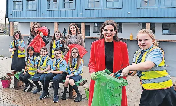  ?? ?? Well done Councillor Katy Loudon, chair of education at the council, congratula­tes Cambuslang children on their efforts tidying up the area
