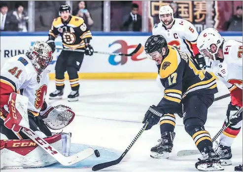  ?? PROVIDED TO CHINA DAILY ?? Boston Bruins forward Ryan Donato is thwarted by Calgary Flames goaltender Mike Smith in the first period of Wednesday’s finale of the 2018 NHL China Games at Cadillac Arena in Beijing. After winning the opener 4-3 in Shenzhen last Saturday, the Bruins swept the preseason series with a 3-1 win in the capital.